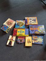Photo showing multiple nostalgic board games and books including Rules of the Game!, Survivor, Nick at Night, Jeopardy, The Office, Scene It? and others.