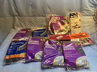 All new, unopened winter weatherproofing items including various MD Air Conditioner Weatherseal kits, a Backer Rod foam seal, and vent and window insulation products arranged on a cloth backdrop.