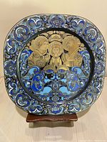 Full front photo of hand painted Christmas plate showing nativity scene with blue and gold patterns.