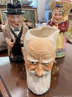 Three vintage Toby mugs - Winston Churchill, George Bernard Shaw, and peasant woman shown together