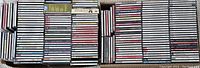 Photo showing multiple rows of classical music CD jewel cases stacked tightly together, visible titles on spine indicating various classical music works and artists.