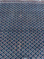 Close-up of medallion pattern on navy field