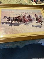 Angled view of the framed lithograph showing the scene of horses and riders.