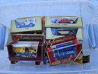 Plastic tub containing eleven Matchbox Models of Yesteryear diecast vehicles in original boxes, showing colorful display packaging with clear window panels, some boxes with minor wear.