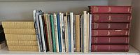 Wide view of full shelf showing all poetry books with various bindings and sizes.