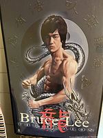 Full view of framed Bruce Lee poster showing muscular Bruce Lee with dragon background and titled "The Dragon".