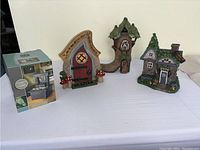 Photo of 3 fairy houses and boxed fountain, showing scale and style