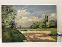 Full view of the oil painting propped against wall with scale bottle