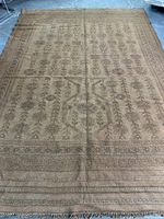 Full overhead view of rectangular kilim rug displaying overall geometric leaf and border pattern