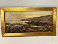 Front view of the full painting and gilt wood frame showing the rocky coast scene