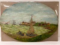Full view of the oval watercolour showing boats on the water and village in the background with church steeple.