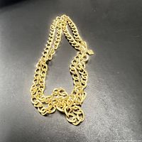 Full view of the gold tone chain necklace showing the entire length and chain style.