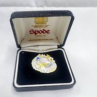 Porcelain brooch displayed in original Spode presentation box with black velvet interior and Spode branded lid.
