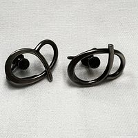 Pair of vintage looped sterling silver screw back earrings shown front side with visible tarnish and patina.