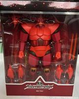 Front view of Armored Mon Star figure displays brightly colored red and maroon articulated action figure with multiple accessories inside plastic window.