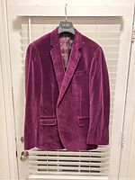 Front full view of plum velvet dinner jacket showing notch lapels, three front pockets, and smooth texture.