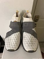 Front view of the pair of ASICS running shoes highlighting textured knit upper and elastic straps.