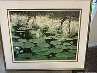 Front view of the oil painting showing lily pond scene