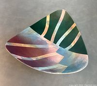 Top view showing the triangular art dish with multicolor abstract pattern
