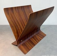 Angled side view showing the curved bentwood and rich wood grain pattern