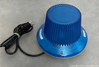 Bottom view showing power cord and bottom base of blue knob lamp.