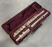 Flute fully assembled in case with maroon velvet lining