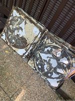 Shows two Victorian tin ceiling tiles with floral and geometric embossed patterns. Paint is peeling away.
