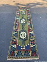 Full length view of the Axminster style carpet runner showing its pattern and colors.