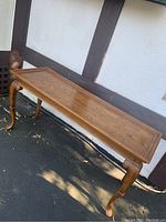 Full view of console table showing rectangular top and four cabriole legs