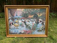 Wide shot of the entire framed print displayed outdoors showing the detailed dinner scene with people in period attire, tables, flowers and garden setting.