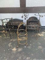 Overview of entire lot showing black iron fire grates, planter stand, firewood holder, and wind chimes.