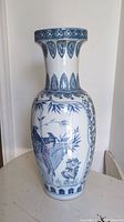 Full view of tall Chinese baluster vase with hand-painted pheasant and bamboo design, blue and green palette