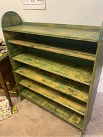 Front view of the wooden shelf showing five adjustable shelves with green rustic finish.