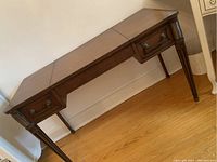 Full view of the dressing table showing its flat top and tapered legs with carved detailing.