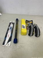 Photo showing two Stanley retractable utility knives and various packs of blades and accessories on a white counter