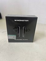 Front view of the sealed box showing Monster branding and product image.