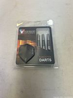 Set of three new Victory tungsten dart barrels with black grooved rings and dart flights in blister packaging.