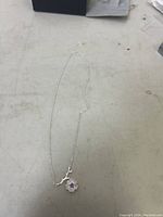 Full view of the sterling silver 925 flower necklace, showing the chain laid out flat.