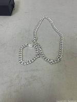 Photo showing the sterling silver chain and bracelet laid out on a flat surface.