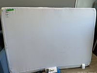 Full mattress with fitted white cover, minor marks noted