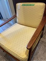 Front view showing wood frame, armrests, seat and back cushion