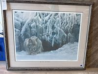 Full view of the framed limited edition print featuring a bobcat in a snowy landscape with a grey wood-grain frame and off-white mat.