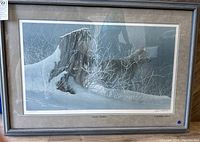 Framed print showing the wolf in snowy forest setting with tree stump and frosted branches, titled "Lupine Shadows".