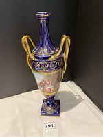 Full frontal view of the urn on a white cloth against a black background