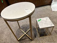 Image showing the two side tables side by side, highlighting the size difference and matching materials of white marble and gold metal frames.