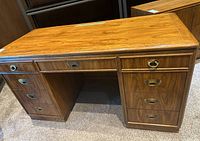 Front perspective of desk showing dual pedestal drawers and central knee space