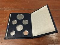 Opened black folder containing six Canadian coins from 1981 uncirculated set.