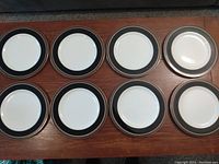 Overview photo showing all eight dinner plates laid out in two rows on a table.