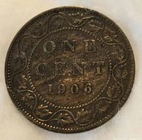 Reverse side of 1906 Canadian large penny with denomination 'ONE CENT' and date 1906 surrounded by maple leaves.