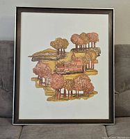 Front view of the framed print showing the overall artwork with stylized trees and buildings